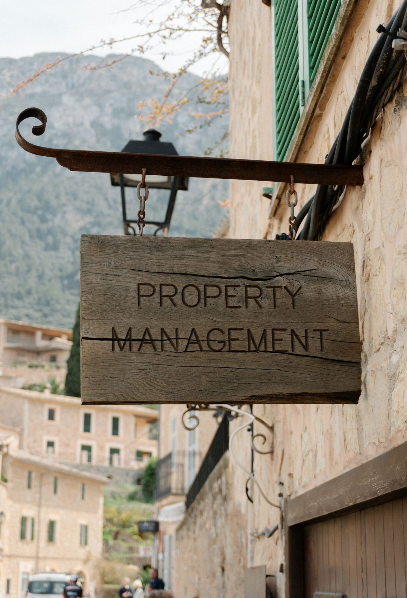 Property management sign hangs on a building.